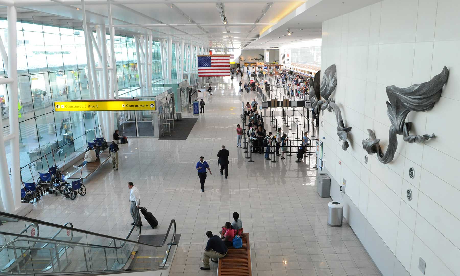 People moving about an airport terminal.